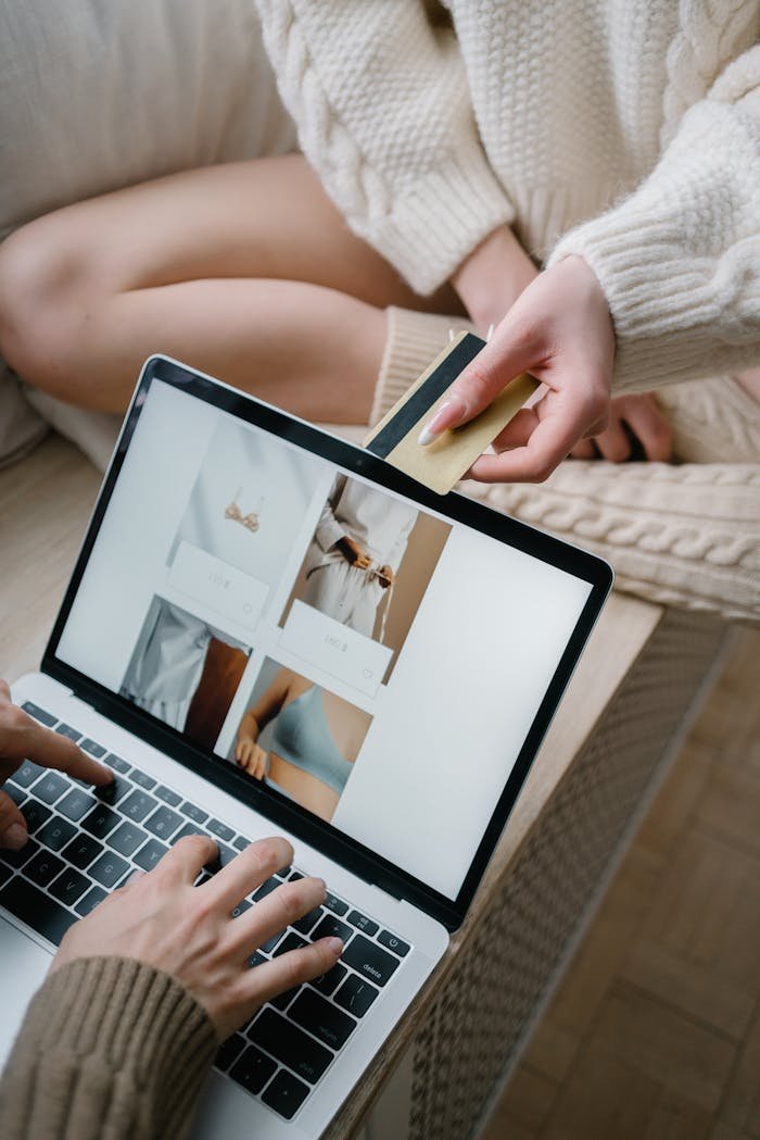 Person using a laptop for online shopping while holding a credit card.
